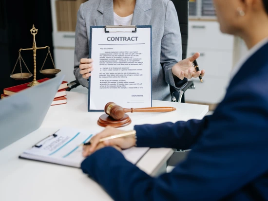 Close-up of a contract or workplace policy document with a pen and checklist, representing steps employees can take when experiencing a hostile work environmen