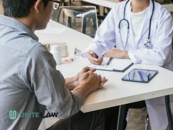 Healthcare provider discussing medical leave documentation with a patient during an office consultation.