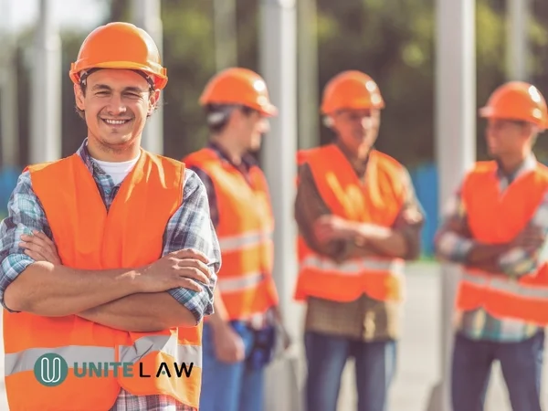 Construction workers wearing safety gear at a job site, representing employment classification in Connecticut.